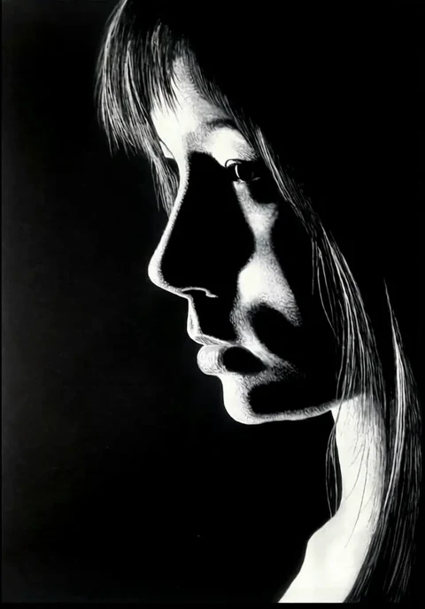 Monochrome profile portrait lit dramatically against black